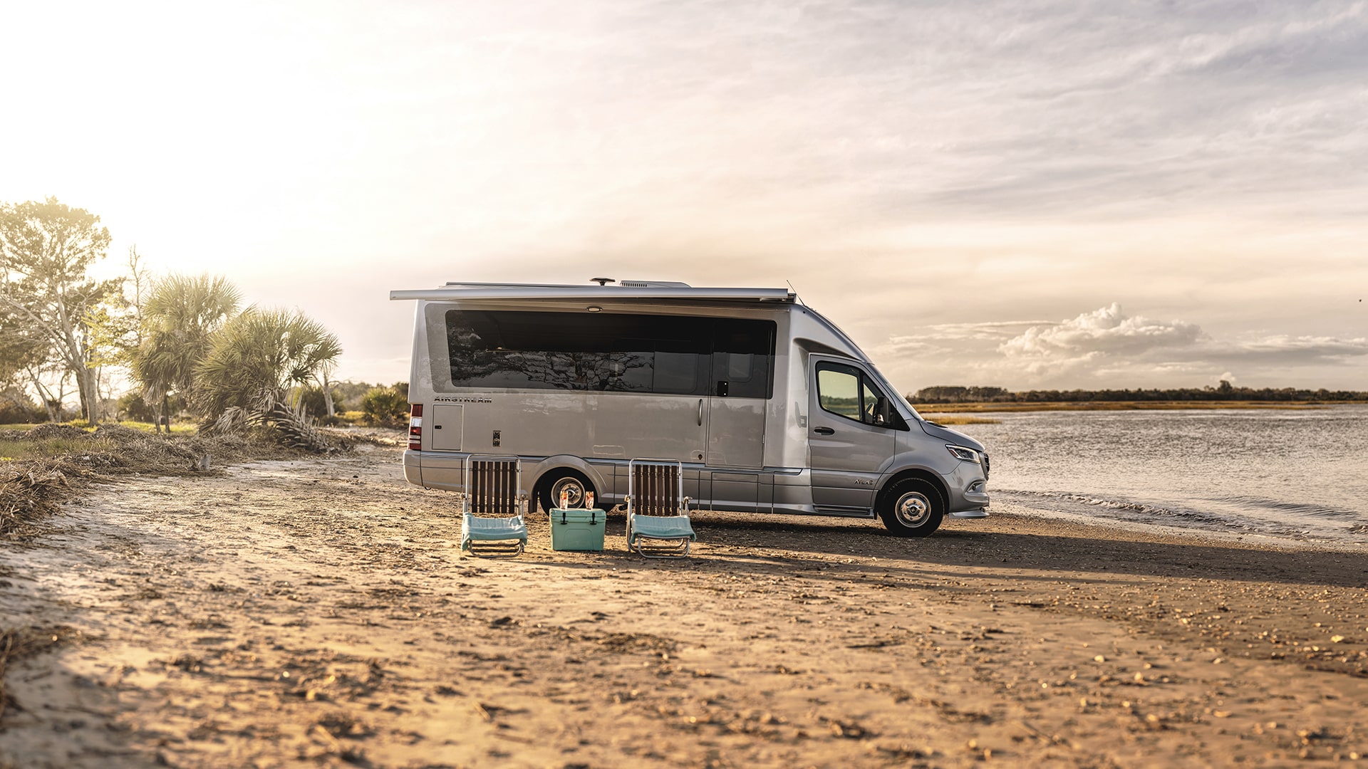 Airstream-Atlas-Lifestyle-Exterior-Curb-Side-on-the-Beach-Luxury-Class-B-Motorhome-min