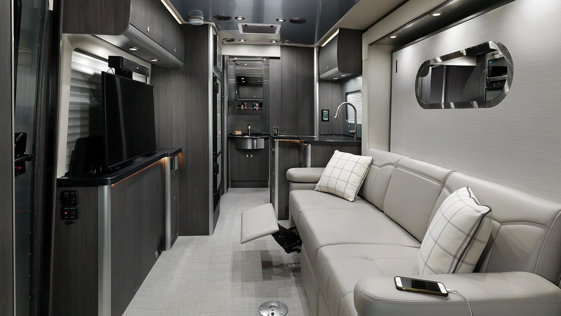 MY2020-Airstream-Atlas-Interior-Modern-Greige-Recliner-Up-TV-Up-min